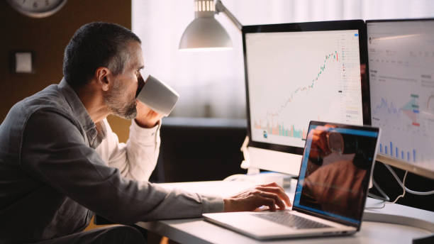 istock Stock trader working in hybrid workplace. 1966125200