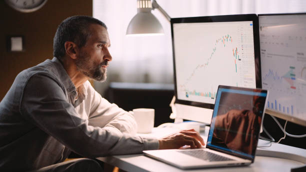 istock Stock trader working in hybrid workplace. 1966125206