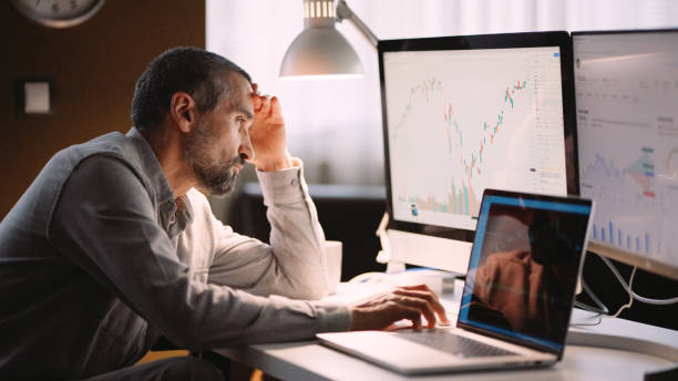 istock Stock trader working in hybrid workplace. 1966125207