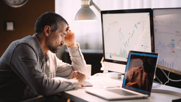 istock Stock trader working in hybrid workplace. 1966125208
