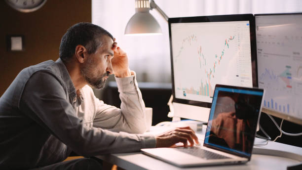 istock Stock trader working in hybrid workplace. 1966125209