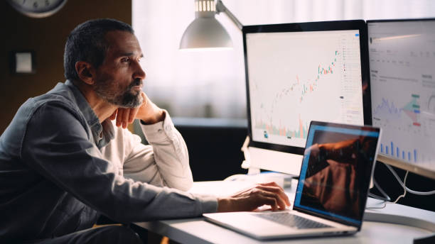 istock Stock trader working in hybrid workplace. 1966125712