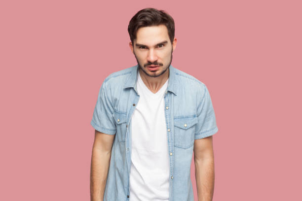 istock Bearded man standing frowning, having grumpy angry look, dissatisfied with misbehavior of somebody. 1966125742