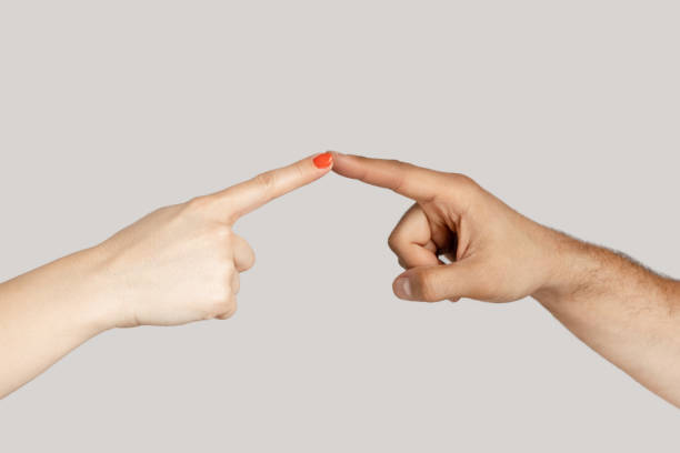 istock Woman and man opposed hands pointing touching at each other wit index fingers. 1966126807