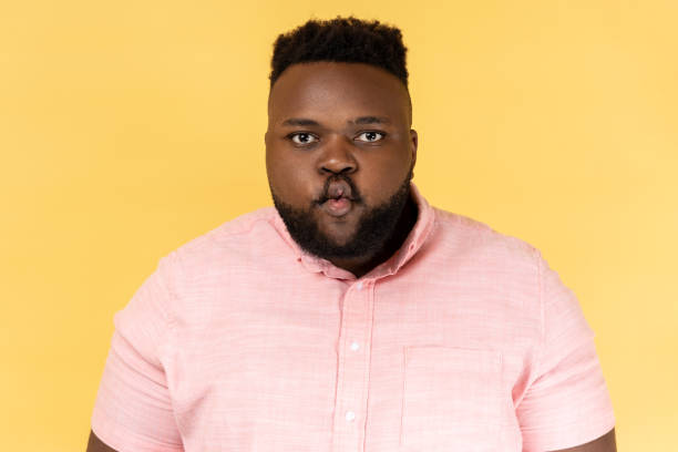 istock Man standing with pouted lips making fish face, having fun, childish good mood. 1966174452