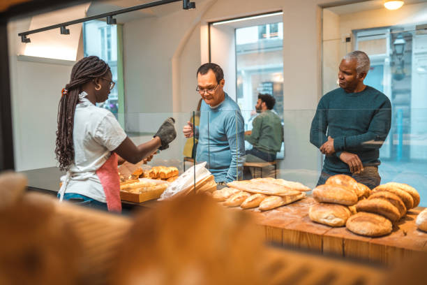 istock Black Female Offering Freshly Baked Bread At An Artisan Bakery 1966175530