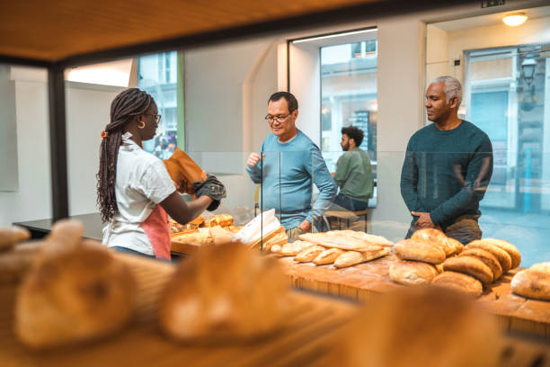 istock Diverse Customers Standing In Line For Freshly Baked Pastries In An Artisanal Bakery 1966175542