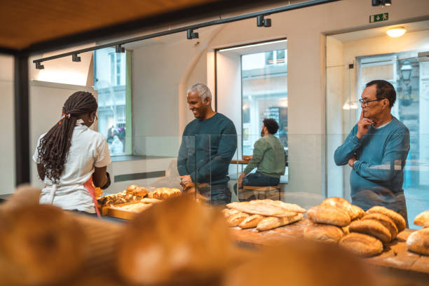 istock Diverse Customers Buying Baked Goods In Small Artisan Bakery 1966175546