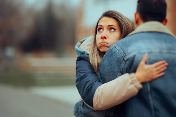 istock Insincere Girlfriend Hugging her Boyfriend on a Date 1966254175