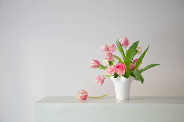 istock pink spring flowers in white ceramic vase in modern home interior 1966267950