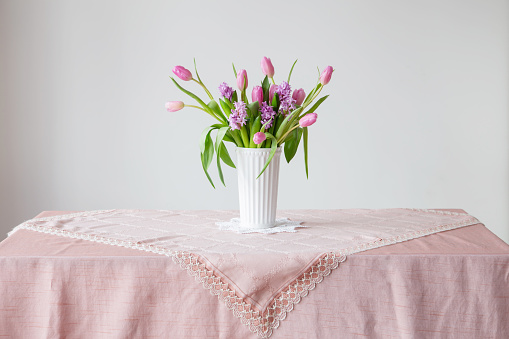 spring flowers in white vase in vintage style