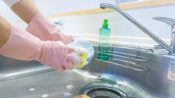 istock person washing dishes in the kitchen 1966301655