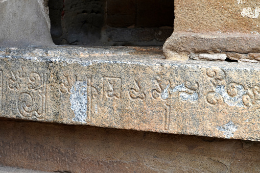 Inscriptions of Tamil language carved on the stone walls at Kailasanathar temple in Kanchipuram. Indian rock art relief carvings of Historical ancient vintage Tamil text in Temples.