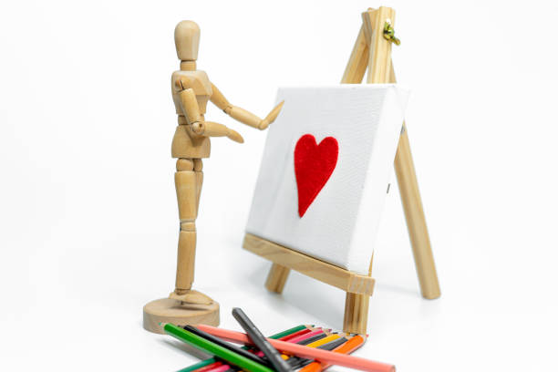 Mannequin with easel on white background; love concept