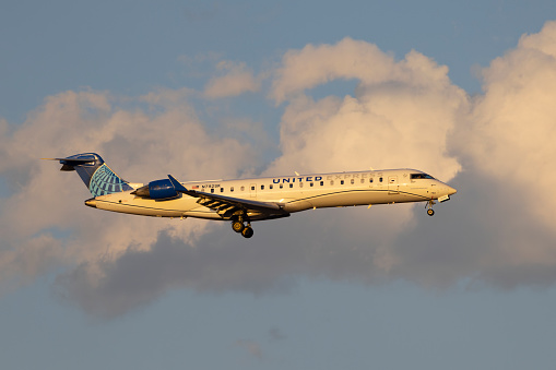 Denver, Colorado, USA - September 8, 2023: A United Express Bombardier CRJ-700 operated by SkyWest comes in for landing at Denver International.