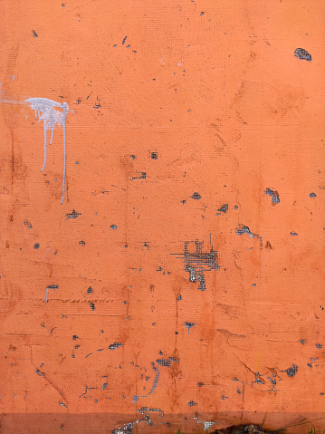 Orange Texture old wall background with peeling paint, scratches and cracks
