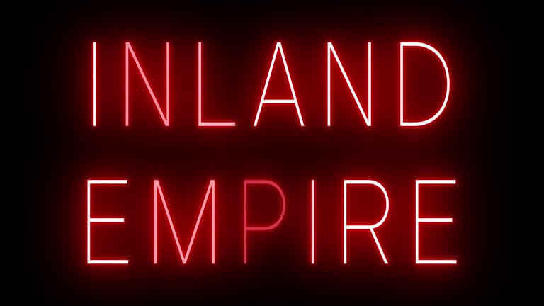 Glowing and blinking red retro neon sign for INLAND EMPIRE