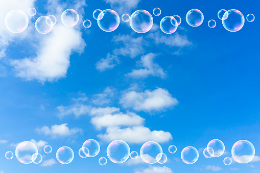 Background material of blue sky with rainbow, clouds and soap bubbles