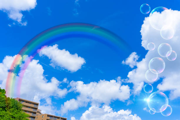 Background material of blue sky with rainbow, clouds and soap bubbles