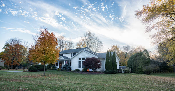 istock Autumn Maple Leaf Color and Suburban Colonial House 1966610413