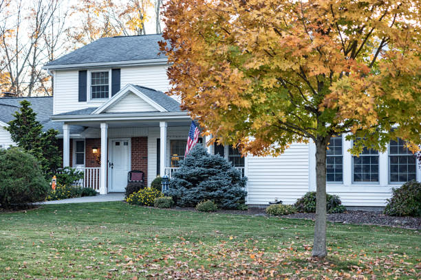 istock Autumn Maple Leaf Color and Suburban Colonial House 1966610998