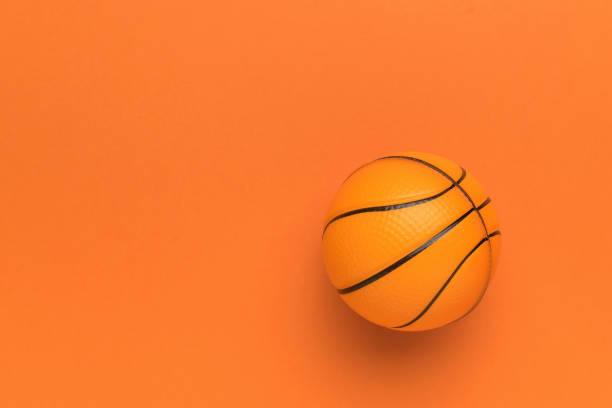 istock A bright basketball on an orange background. 1966614996