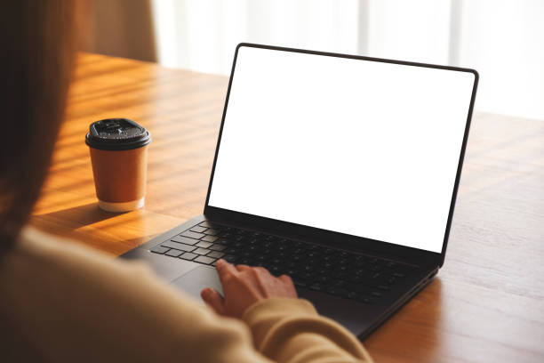 istock Mockup image of a woman working and typing on laptop computer with blank white desktop screen at home 1966772418