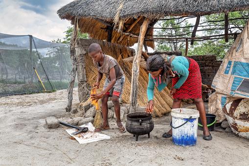 african village family cooking food in the outdoors kitchen