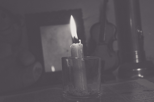 a candle burning in a dark room