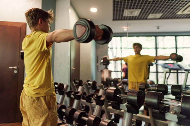 Teenage boy exercising in a gym
