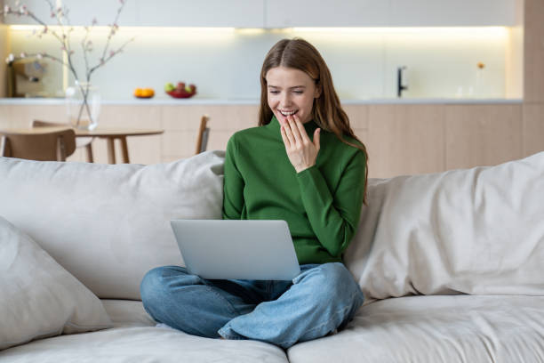 istock Smiling woman holding laptop on knees, having video call, online communication, web chatting 1967060127