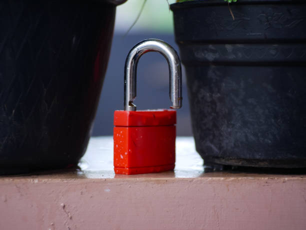 istock The red padlock was wet from the rain and was already open 1967076868