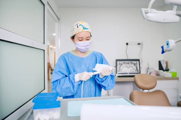 Asian Chinese female dentist doing cleaning for the next patient.