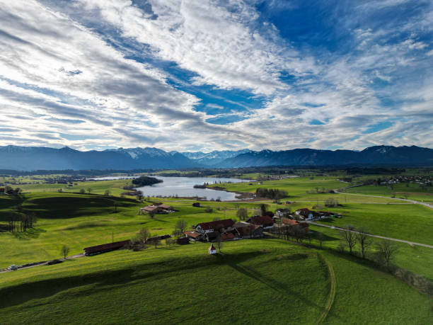 Aerial view on scenic landscape in Bavaria with Lake Riegsee and the Alps in the background