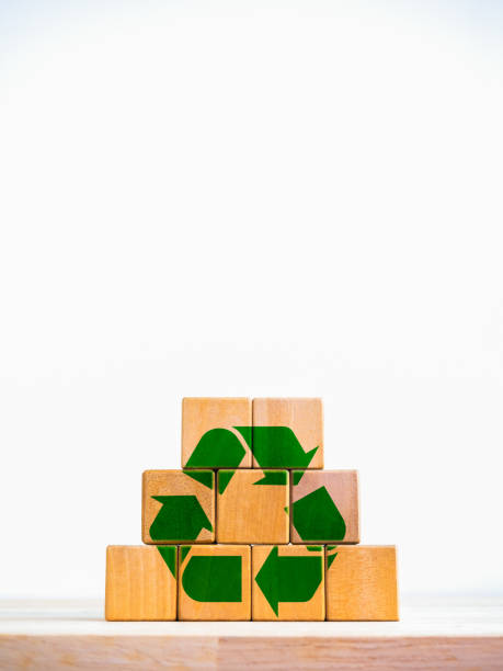 istock Recycle for save the earth, global warming, environment care, reduce, reuse concepts. Green recycle arrow icon symbol on wood cube puzzle pyramid shape isolated on white background, vertical style. 1967128398
