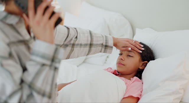Mother, phone call and sick child with fever, infection or illness in bed for healthcare, support or advice at home. Mom talking in Telehealth with ill kid or girl in bedroom with virus or cold flu