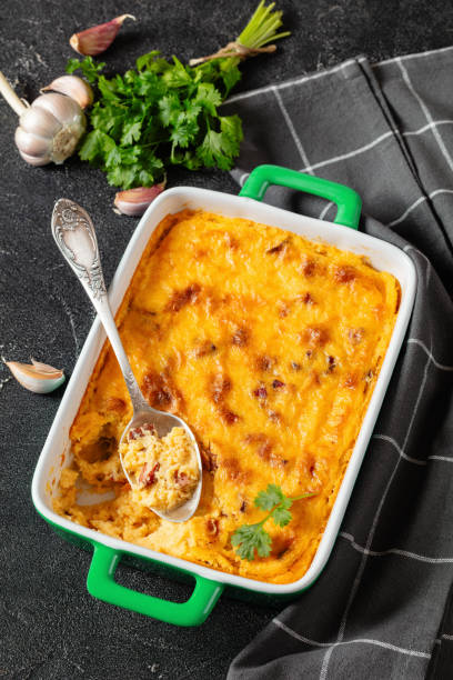 istock cheesy smoked sausage grits bake in ceramic dish 1967135240