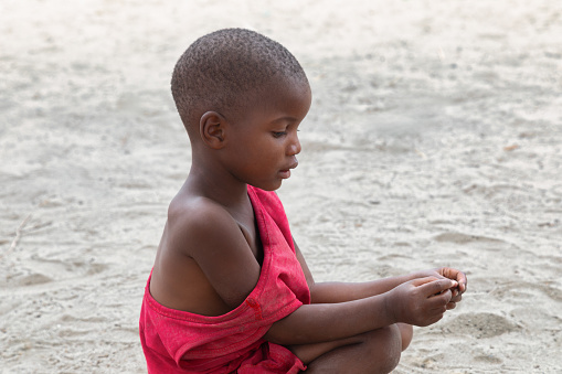 Shot of a young boy playing soccer on a sports field