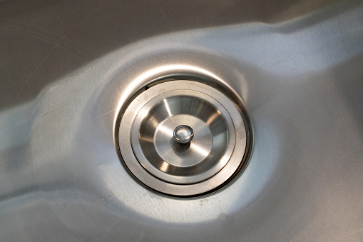 Water running from a faucet in a kitchen sink