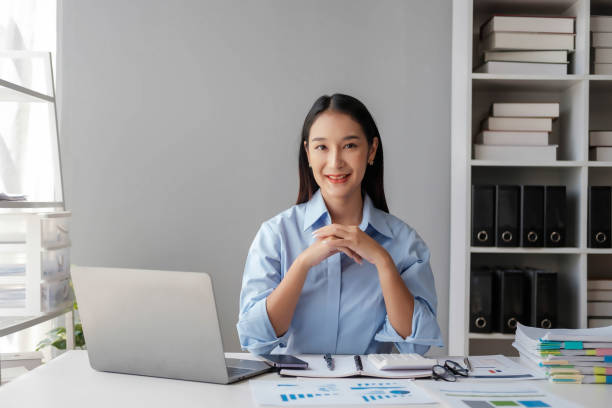 istock Young happy businesswoman using computer in office, Stylish Beautiful Manager Smiling, Working on Financial and Marketing Projects, Portrait of a young businesswoman working on a laptop in an office 1967194945