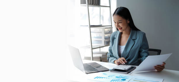 istock Young happy businesswoman using computer in office, Stylish Beautiful Manager Smiling, Working on Financial and Marketing Projects, Portrait of a young businesswoman working on a laptop in an office 1967200786