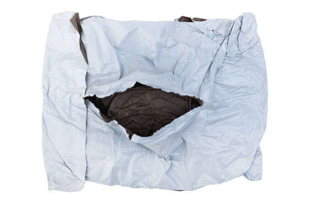 istock Torn white plastic parcel bag isolated on white background. View from above. Open package. 1967235156