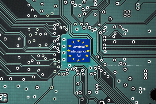 Flag of European Union on a microprocessor, CPU or GPU microchip on a motherboard. Symbolizing the EU recently adopted the AI Act, ushering in new restrictions on AI use cases and mandating transparency from companies, regarding data usage