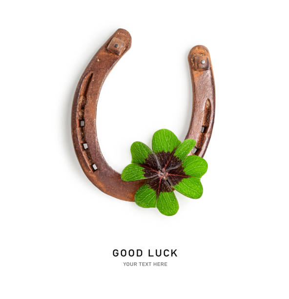 istock Old horseshoe and four leaf clover isolated on white background 1967288986