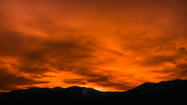 istock Orange sunset over the silhouette mountains. Skyline with orange sunset. 1967341011