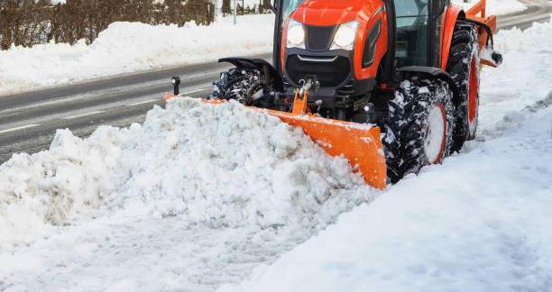 istock The tractor cleans the sidewalk from the pedestrian path in winter 1967341022