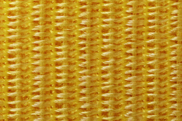istock A close-up of a braided pattern of yellow nylon threads 1967348050
