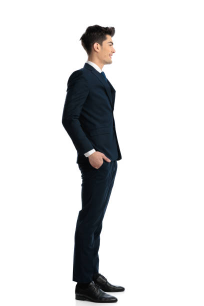 istock handsome elegant businessman with hands in pockets waiting in line 1967373622
