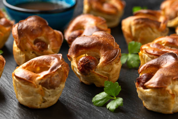 istock Mini Toad in the hole, Baked sausages in Yorkshire pudding with gravy 1967385275