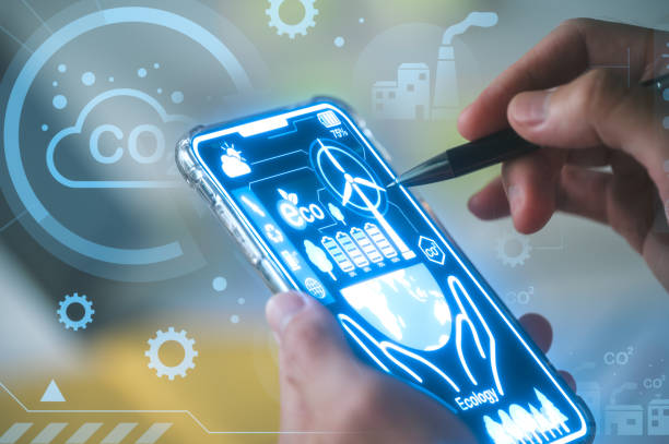 istock hand holding smartphone and using pen to analyst data chart about co2 emission to perform sustainability business 1967405532